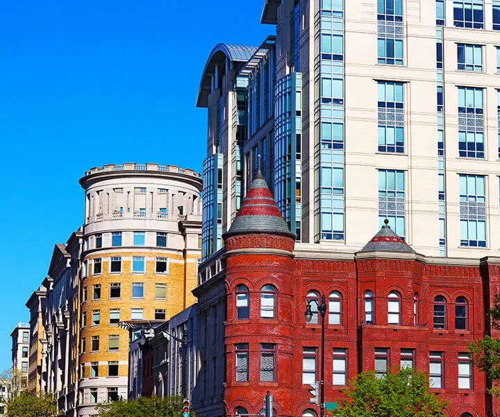 A row of buildings in the city with trees.